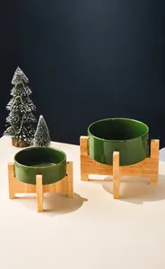 Details von dunkelgrünen Keramiknäpfen mit minimalistischen Holzständern für Haustiere