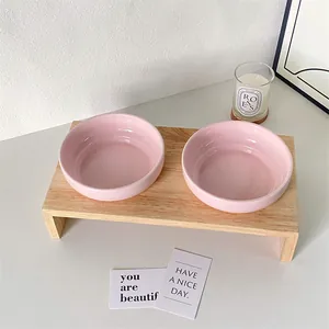 Dual light pink ceramic pet bowls with minimalist solid wood stand for cats and dogs