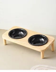 Macro shot of minimalist wooden stand with two black ceramic bowls for cats and dogs