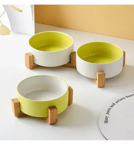 Matte ceramic pet bowl set with ergonomic wooden stand in green and white dual tones