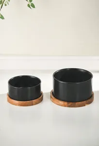 Minimalist matte black ceramic pet bowls with acacia wood stands in two sizes for cats and dogs