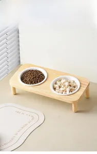 Elevated wooden double pet feeder with two white ceramic bowls for neck protection