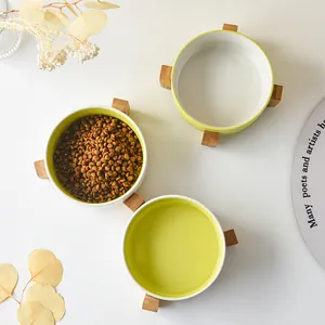 Three matte ceramic pet bowls with bamboo stand for cats and small dogs in green and white