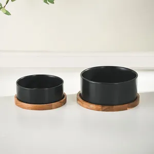 Modern black matte ceramic pet bowls with acacia wood stands for dogs and cats