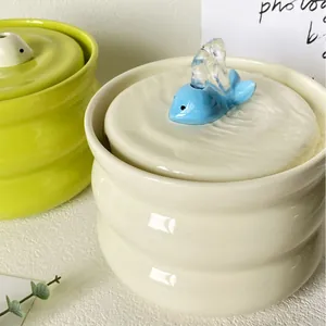 Ceramic pet water fountain with 3D blue whale lid and wave-textured cream body