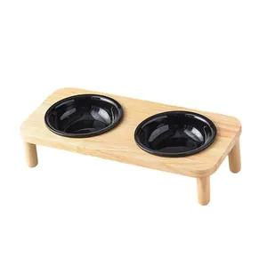 Elevated wooden pet feeder with double black ceramic bowls for cats and small dogs