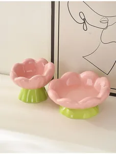 Detail eines tulpenförmigen Keramik-Haustiernapfes mit rosa Blüten und grünem Fuß