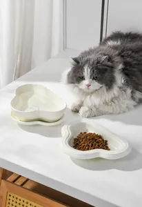 Detailed view of cream ceramic pet cloud bowl set with scalloped edges and non-slip base