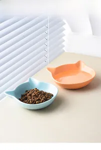 Ceramic cat bowl with ear design showing dry food and water in blue and pink colors