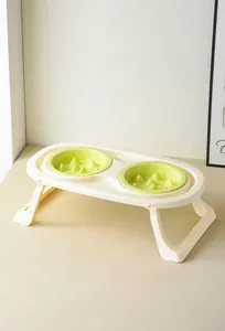 Detail of macaron-colored double slow feeder cat bowls with raised pillars and tilted stand
