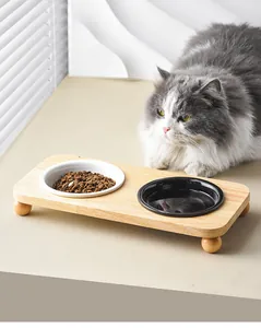 Elevated wooden pet feeder with black and white ceramic bowls for cats and small dogs