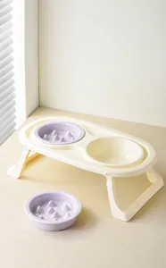 Detail of detachable pet feeding set featuring slow feeder bowls and elevated beige base
