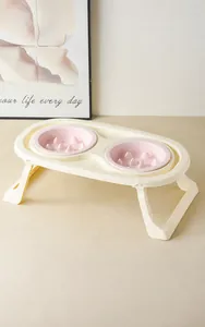 Close-up of foldable elevated double pet bowls with pink slow feeder insert design