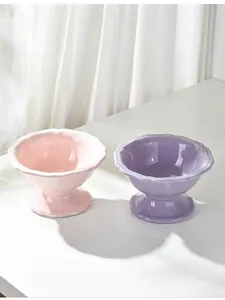 Detailed view of pink and purple elevated ceramic cat bowls with wavy vintage edges