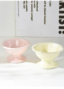 Detail of elegant pastel ceramic elevated cat bowls with scalloped edges and glossy finish