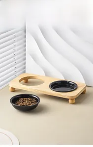Modern elevated black ceramic double pet bowls with a minimalist light wood stand