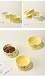 Detail of cream ceramic volcano cat bowls with decorative letters and dry pet food
