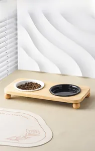 Modern double ceramic pet bowls on a minimalist wooden stand for water and dry food
