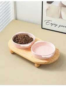 Pink ceramic double pet bowls with elevated wooden stand for cats and small dogs