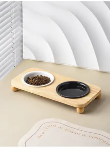 Detailed view of dual ceramic pet bowls on a minimalist solid wood raised stand for cats