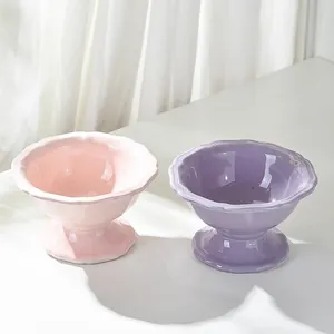Cute elevated ceramic pet bowls with wavy edges in pink and purple for cat neck protection