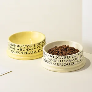Minimalist wide ceramic pet bowls in yellow and white for cats and small dogs