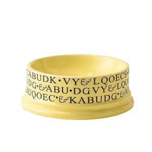Modern volcano-style yellow ceramic cat bowl with black letter print and wide opening