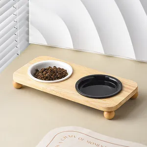 Elevated wooden pet feeder with black and white ceramic bowls for cats and dogs