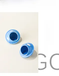 Close-up of sky blue ceramic hamster hideout with white cloud patterns and glossy finish