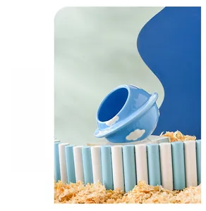 Detailed view of a blue planet-shaped ceramic hamster hideout with rings and clouds
