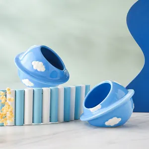 UFO shaped ceramic hamster hideout with blue sky and white cloud patterns