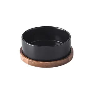 Detail of matte black ceramic pet bowl with premium acacia wood non-slip stand