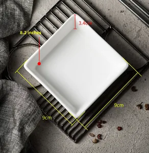 Macro shot of minimalist white square ceramic dip bowl with 9cm dimensions on dark metal rack