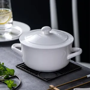 Minimalist white ceramic soup bowl with lid and double handles on a dark grey background