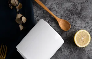 White ceramic chopstick holder and utensil organizer on dark stone countertop