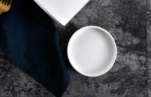 Close-up of white ceramic drip tray with smooth finish for kitchen drying rack