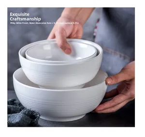 Detail of three-piece creamy white ceramic bowls with horizontal ribbed texture