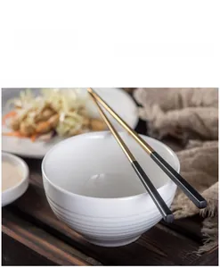 Detail showing white ceramic bowl with unique stepped texture and elegant chopsticks