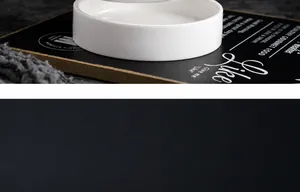 Detailed close-up of creamy white ceramic utensil holder with glossy finish and fine texture
