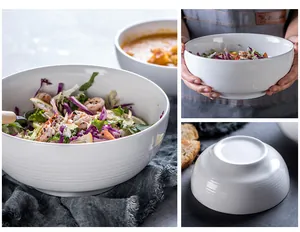 Detail of white ceramic salad bowls with horizontal ribbing in Nordic minimalist style