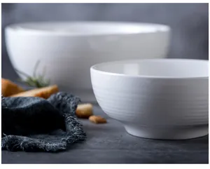 Detailed close-up of ribbed white ceramic bowls with a minimalist Nordic design