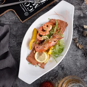 Modern white oval ceramic boat-shaped plate for main courses and salad serving