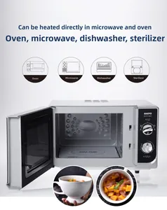Close-up of a white ceramic mug with fruit salad inside a microwave for heating