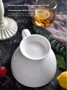 Detail showing the unglazed non-slip bottom of a white ceramic mug on a stone surface