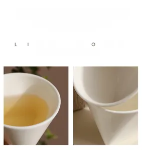 Detailed close-up of creamy white conical ceramic cup with smooth glaze and tea inside