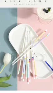 Close-up of multicolored macaron-style ceramic chopsticks on a decorative white tray