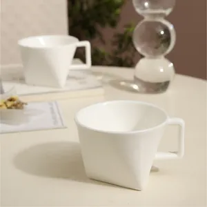 Modern white geometric ceramic mug set with minimalist triangular base and rectangular handle