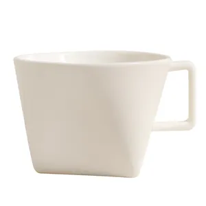 Minimalist white geometric ceramic coffee mug with unique triangular facets and square handle