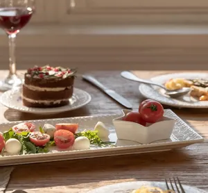 Detail of white ceramic rectangular plate with star bowl featuring embossed pearl texture