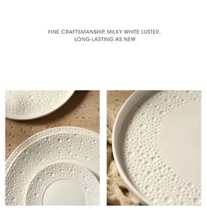 Detailed view of milky white ceramic dinner plates with embossed bubble textured edges